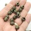 10 floral Beads, antique brass