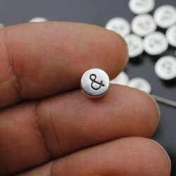 10 Metallperlen "&" Sonderzeichen 7x4 mm (Ø 2 mm)